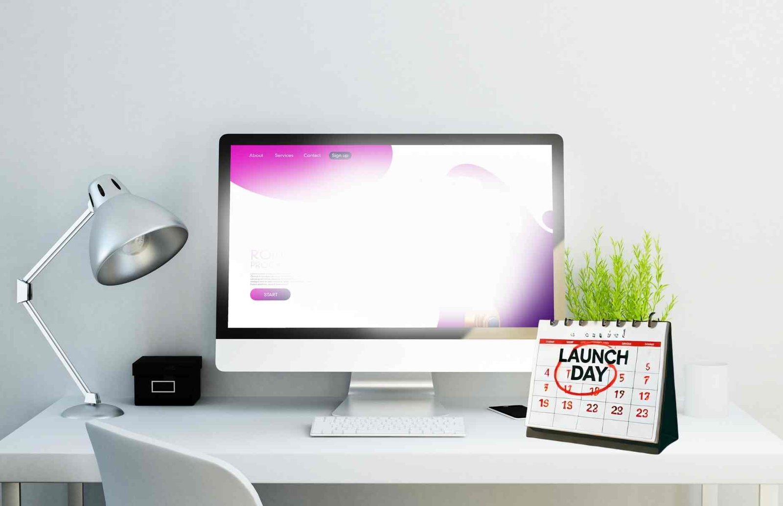 A calendar with “Launch Day” circled in bright red, next to a laptop showing a fresh website.